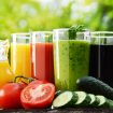 Glasses with fresh vegetable juices in the garden. Detox diet